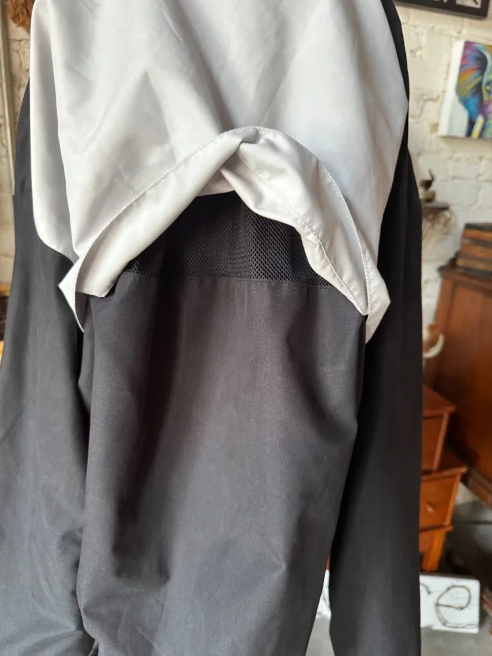 vintage Champion windbreaker jacket featuring a black body with a white chest st